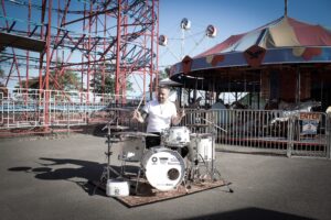 Patrick Blakley drumming by the Galaxi rollercoaster