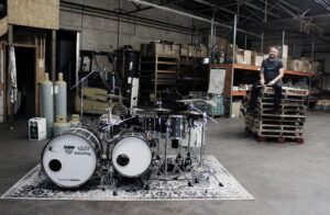 Time Machine drumset with Patrick Blakely sitting on pallets