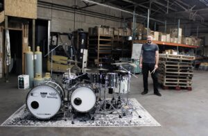 Time Machine drumset with Patrick Blakely standing to side