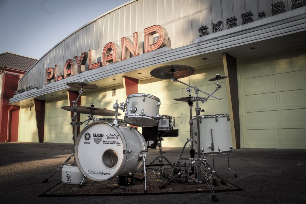 White Noise drum set in front of Playland
