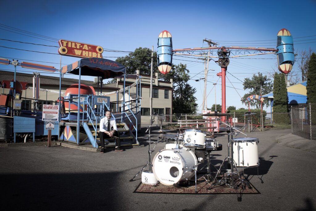 Patrick Blakley at Sylvan Beach Amusement Park with his drum set!